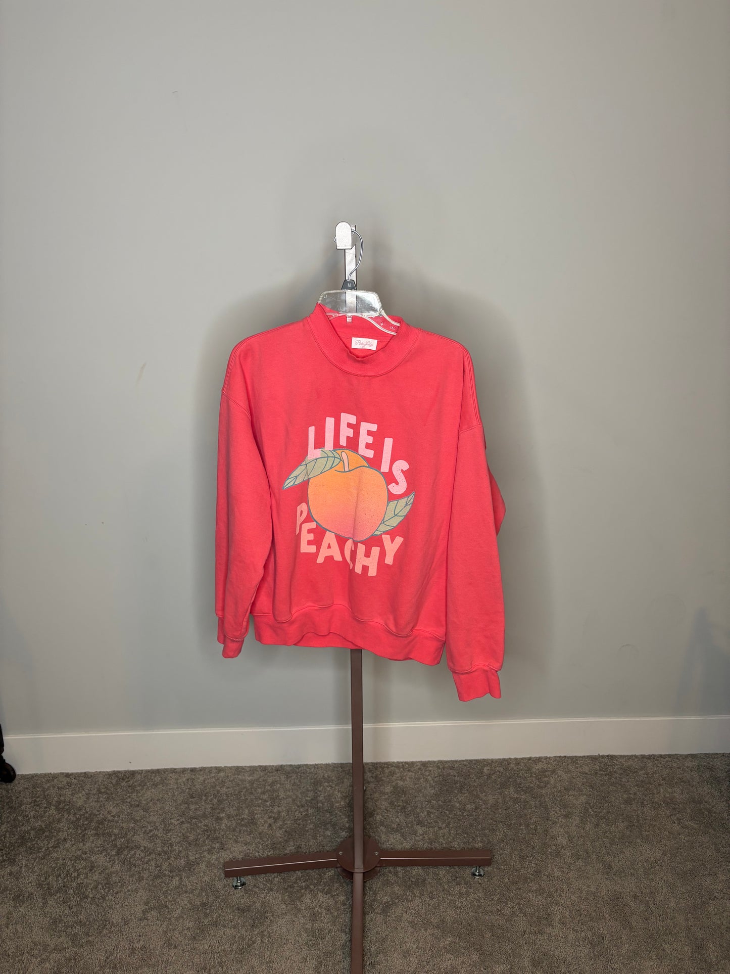Bright pink "LIFE IS PEACHY" sweater