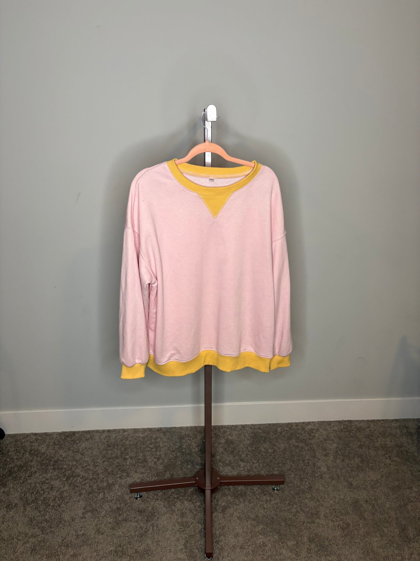 pink sweater with yellow accents