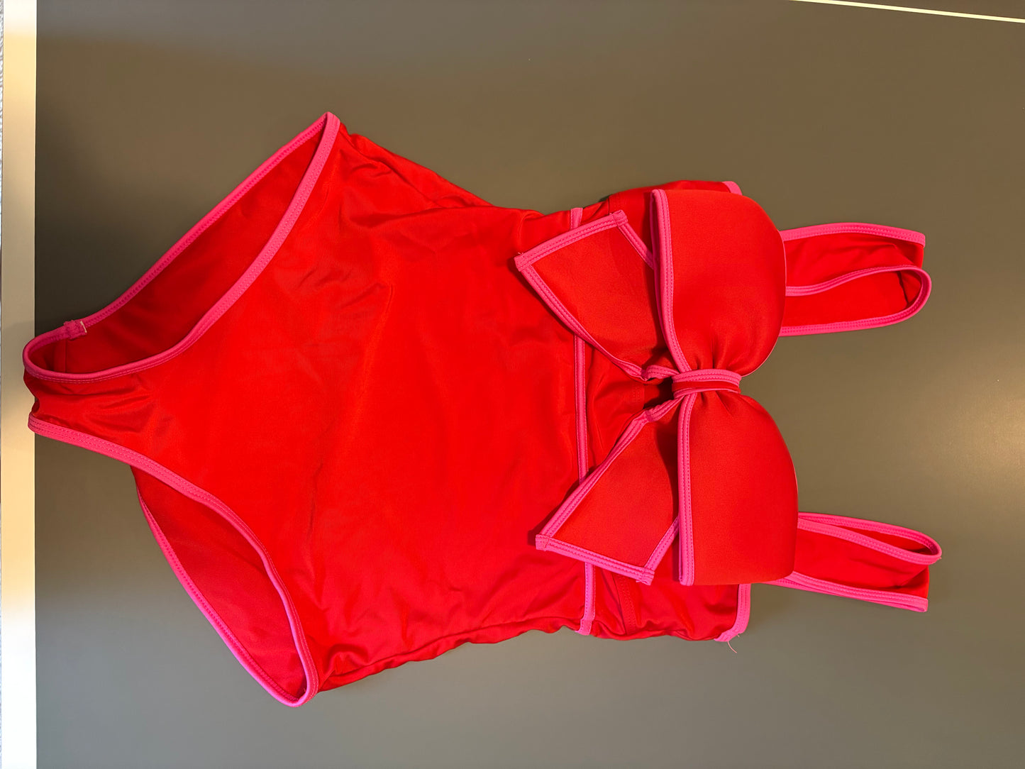red one piece bathing suit with pink trem