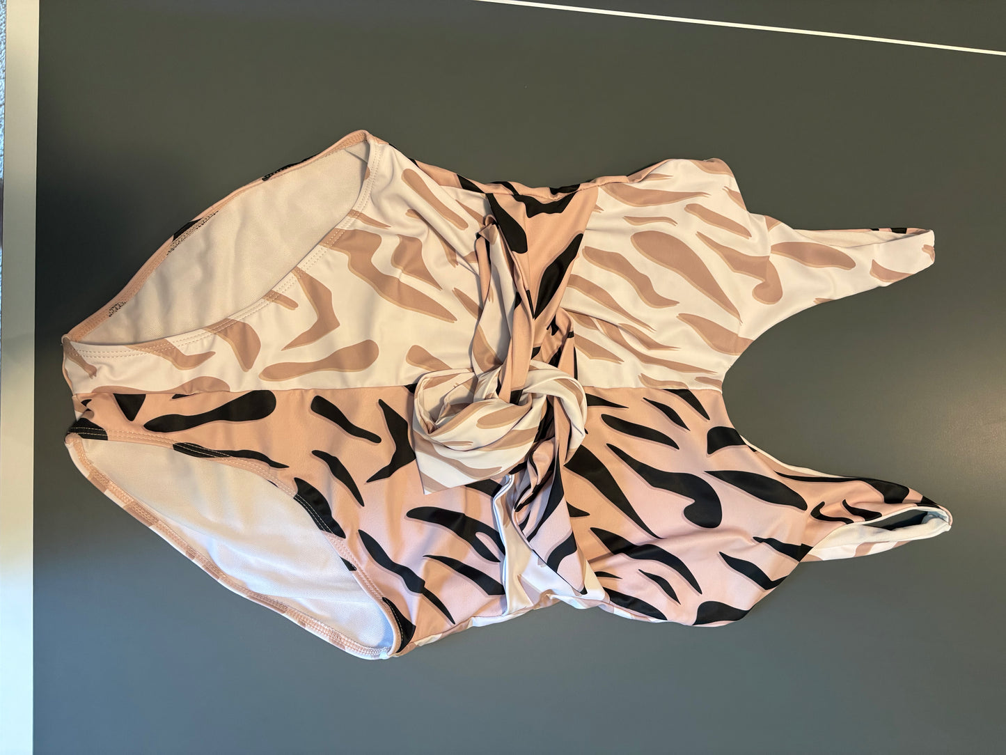 white, tan, and black cheetah print half and half one piece bathing suit
