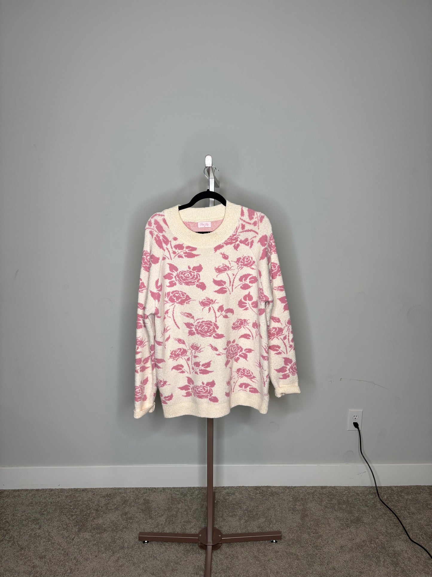 light pink sweater with rose colored floral designs