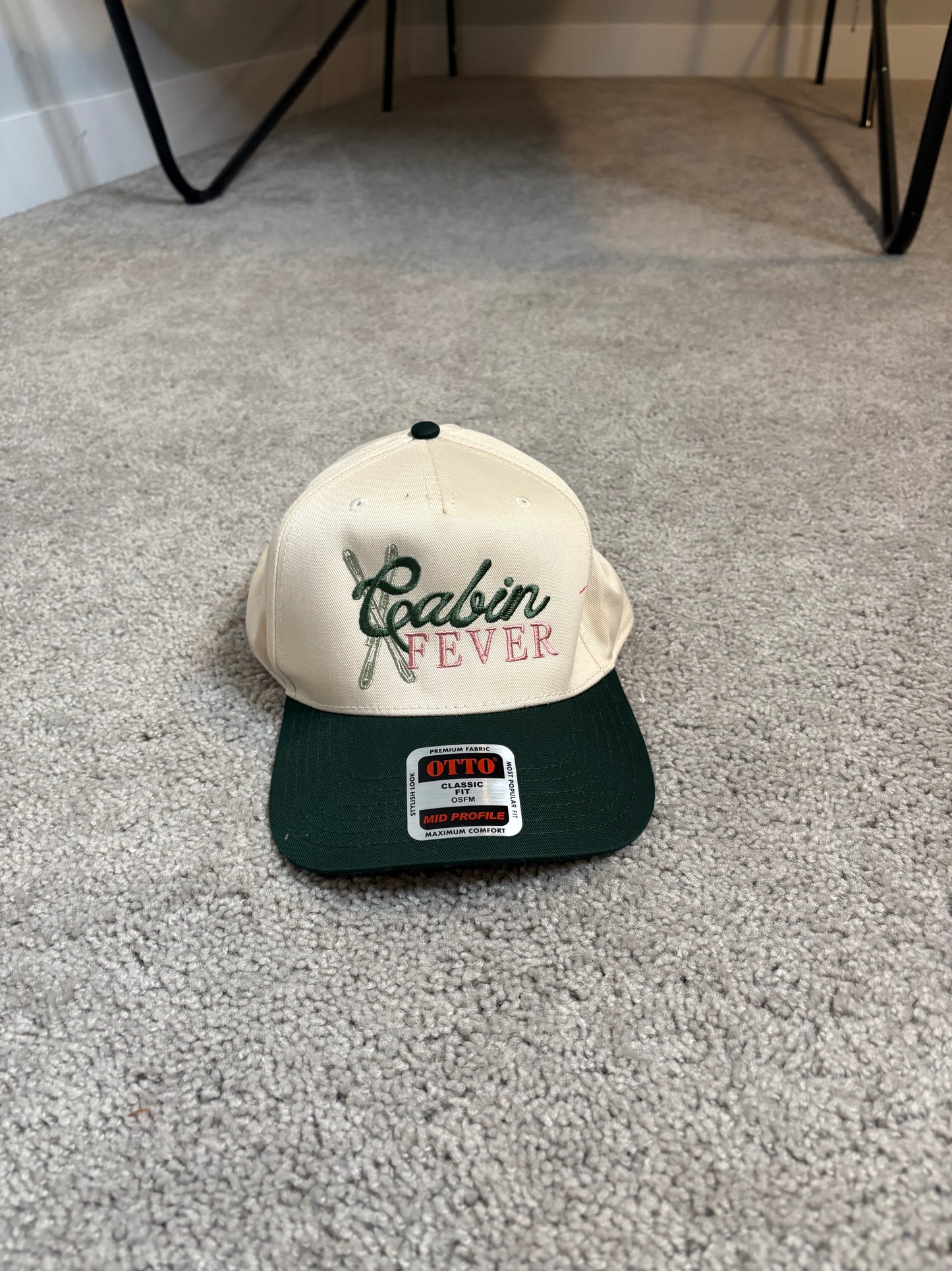 tan and green "CABIN FEVER" hat