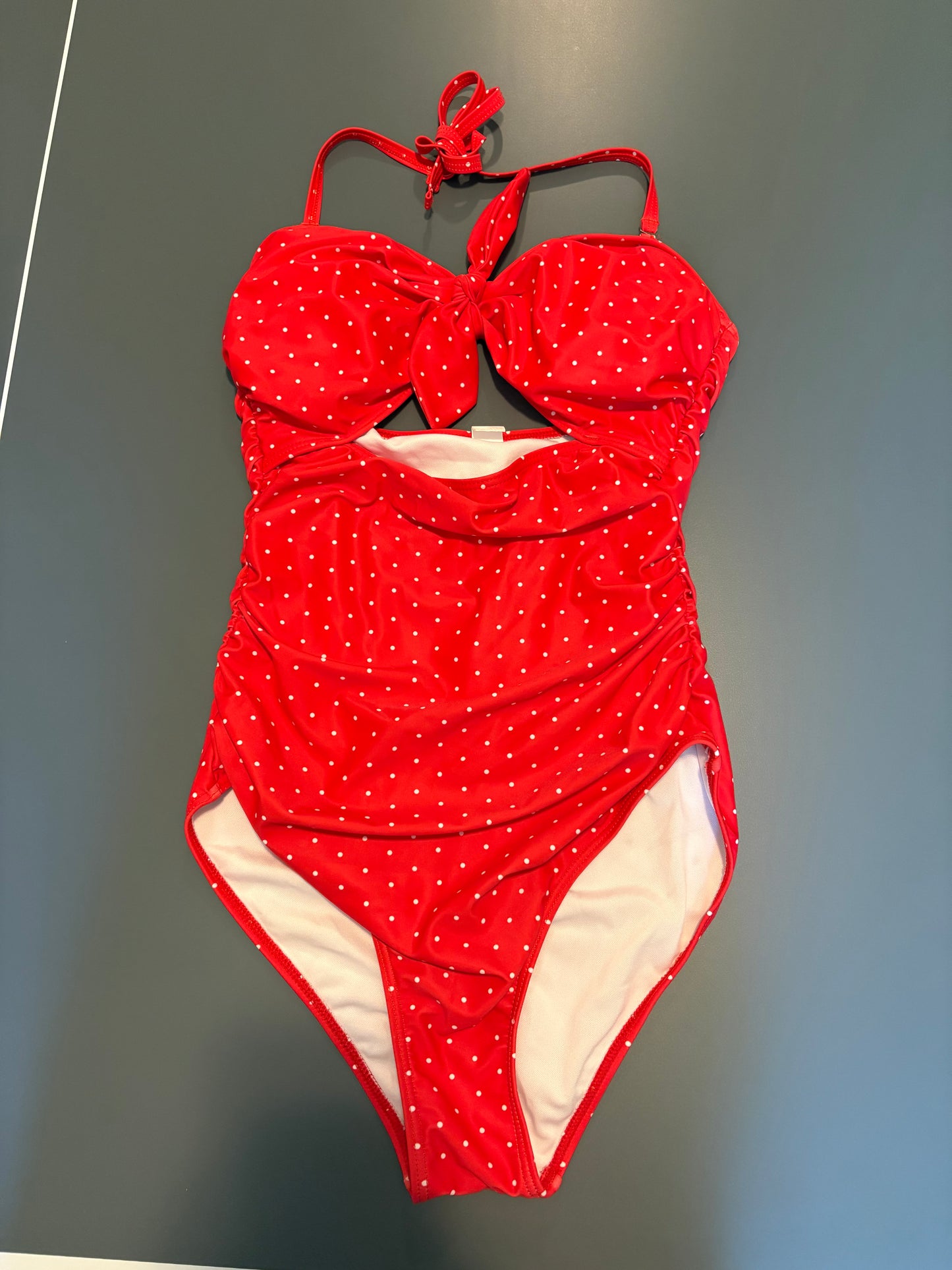 red one piece bathing suit with white polka dots