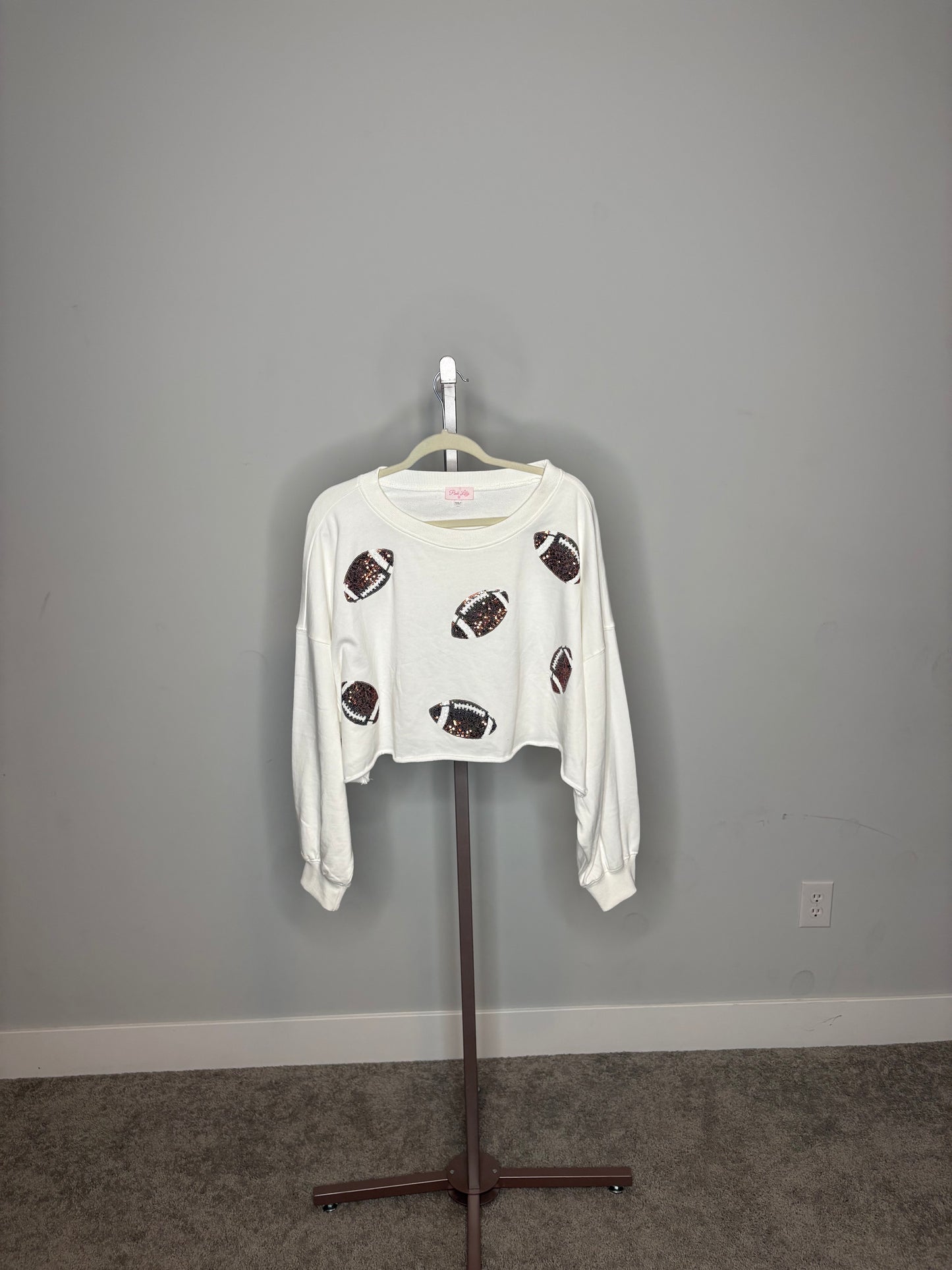white sweatshirt with sequins footballs